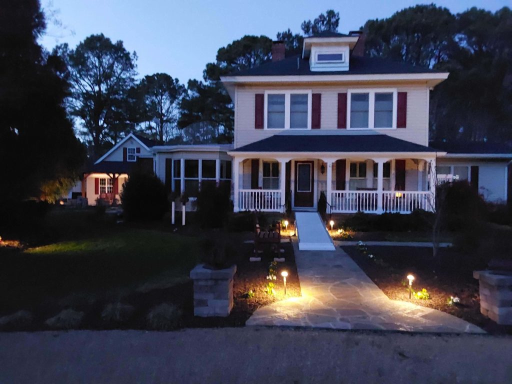 Front of home with breezeway towards the left during the night