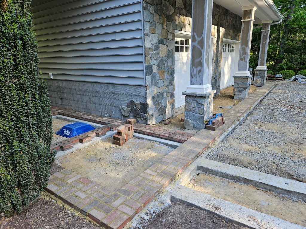 Pavers are done with stone work installed up to siding