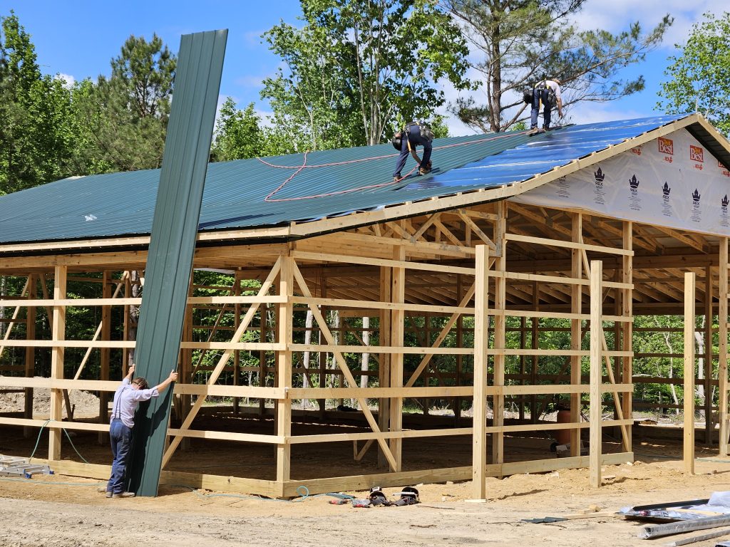 Builder shows roofing of shop