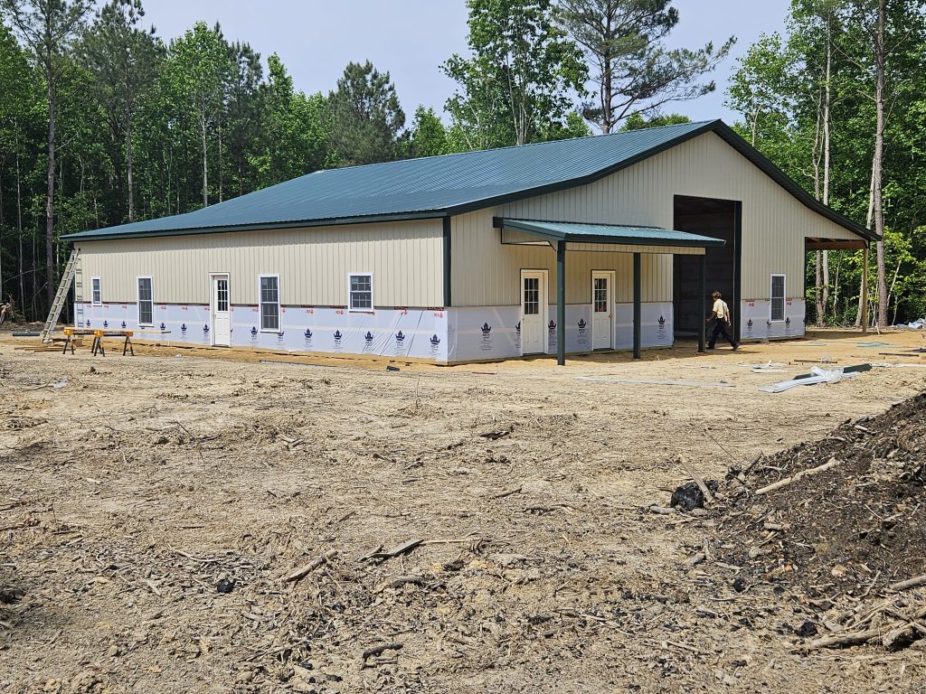 Builder shows exterior of shop completed