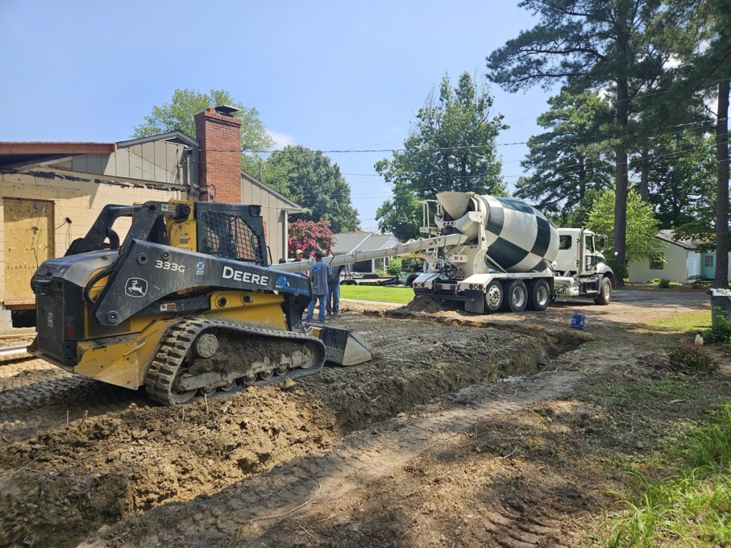 Pouring concrete for foundation of new home addition